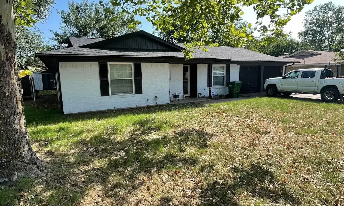 Professional roofing crew working on a residential roof in Glasgow